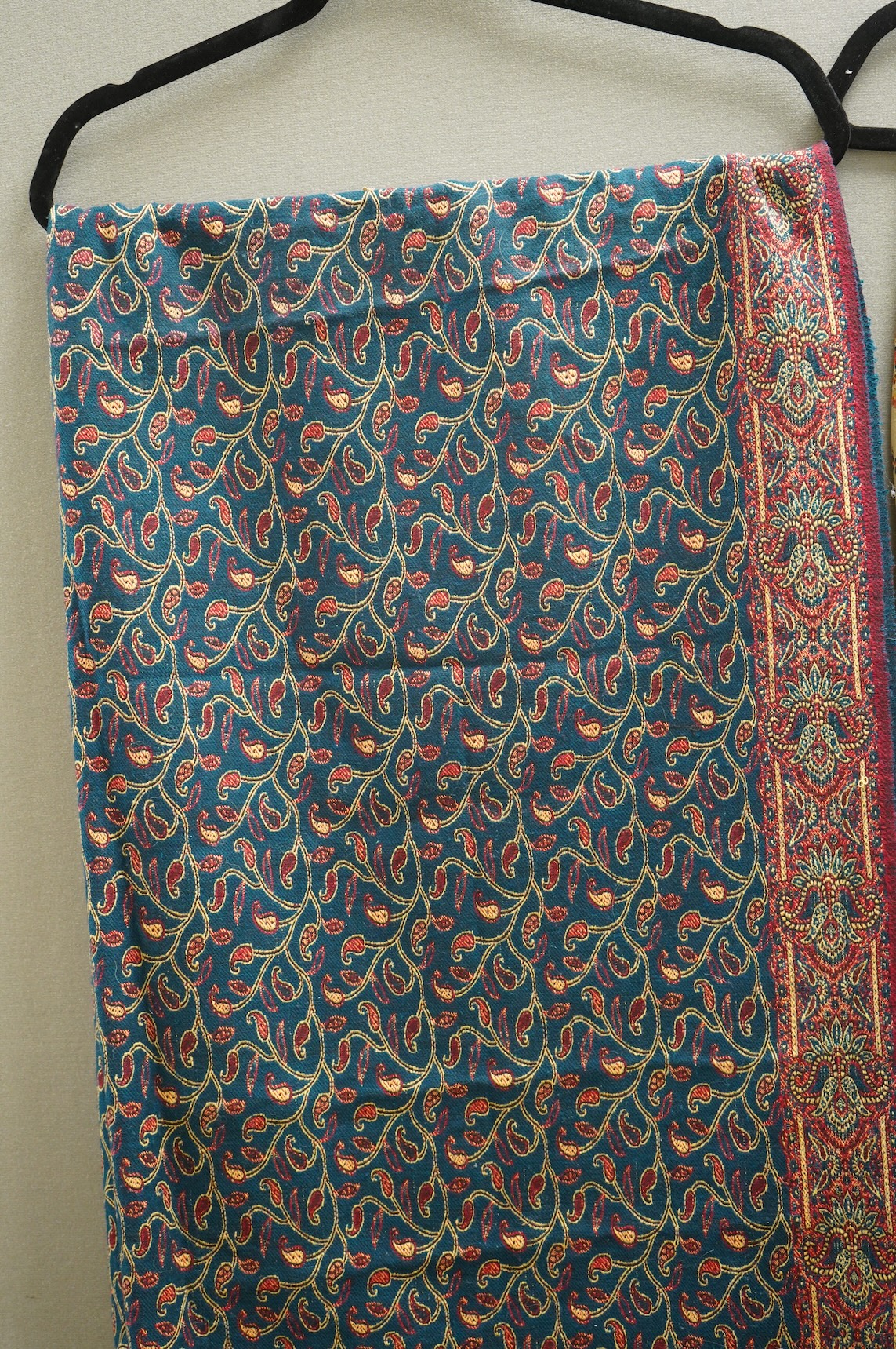 A 19th century printed silk shawl and a printed paisley shawl, together with a late 20th century wool machine woven stole with Oswal label. Condition - the two 19th century shawls are damaged but useful for TV and film c
